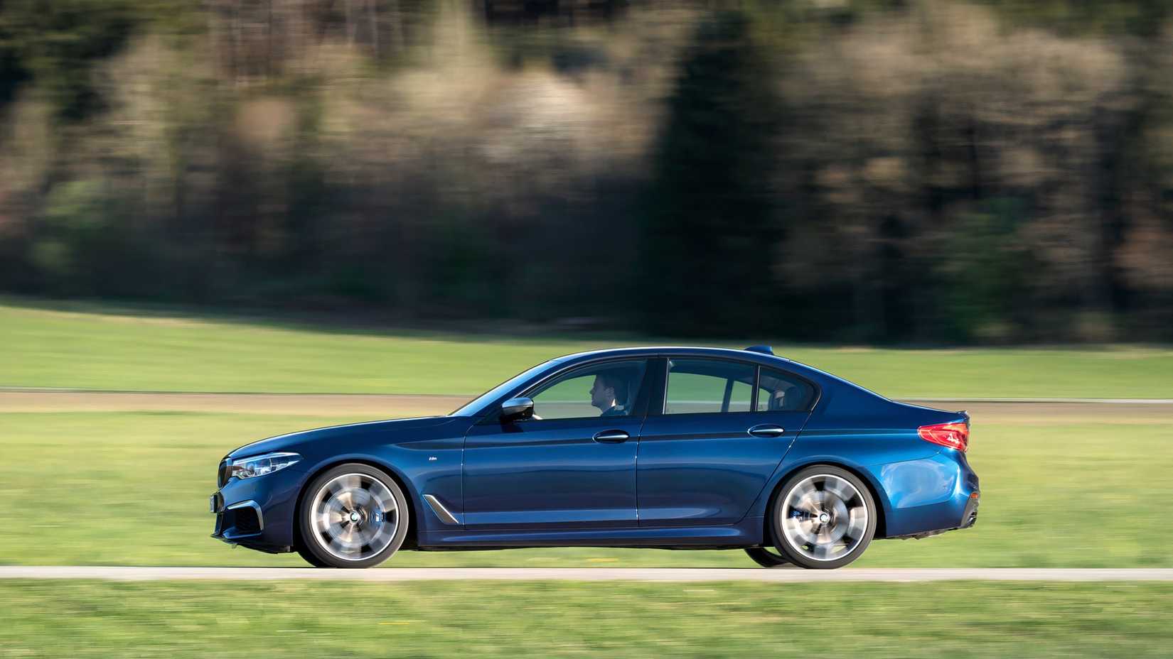 BMW M550i in blue being driven
