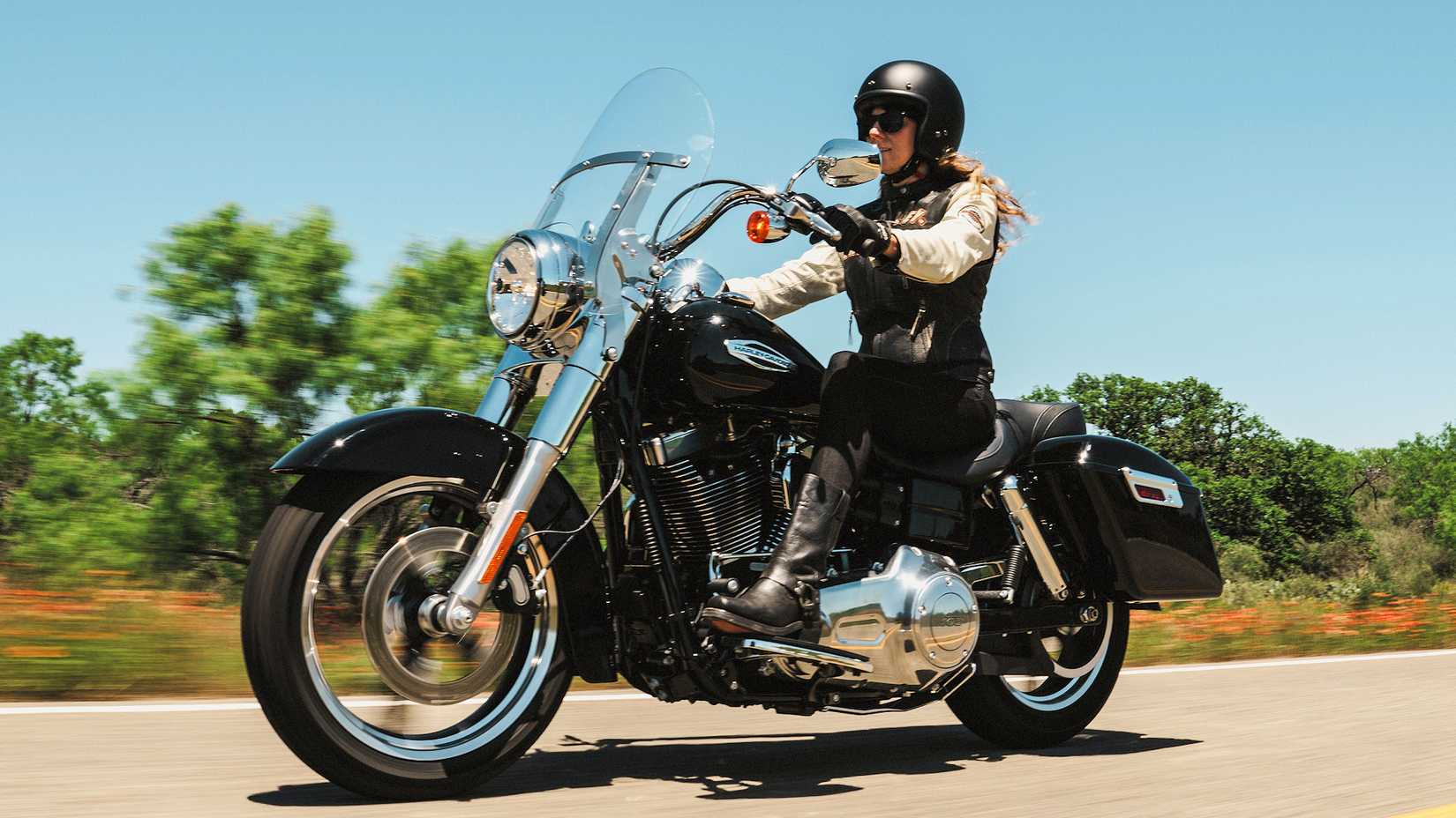 Rider on a 2016 Harley-Davidson Switchback cruising on a country highway