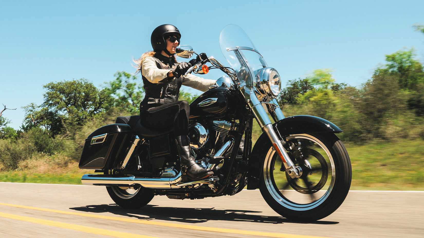 Rider on a 2016 Harley-Davidson Switchback cruising on a country highway