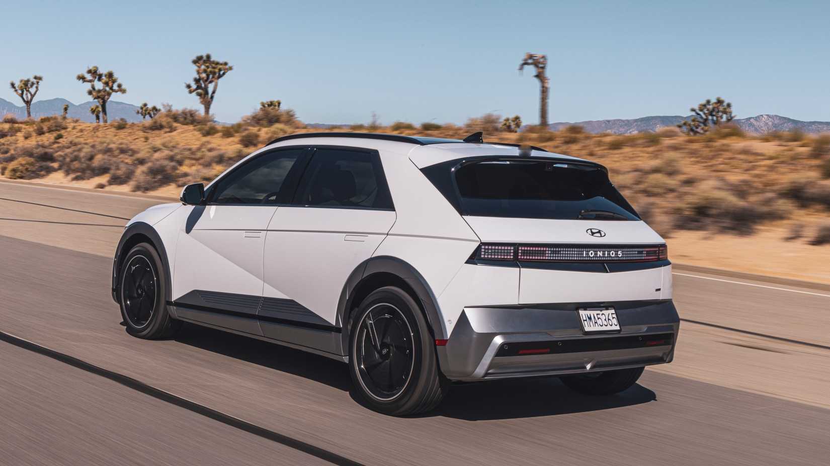 Rear shot of a 2025 Hyundai Ioniq 5 driving through desert road
