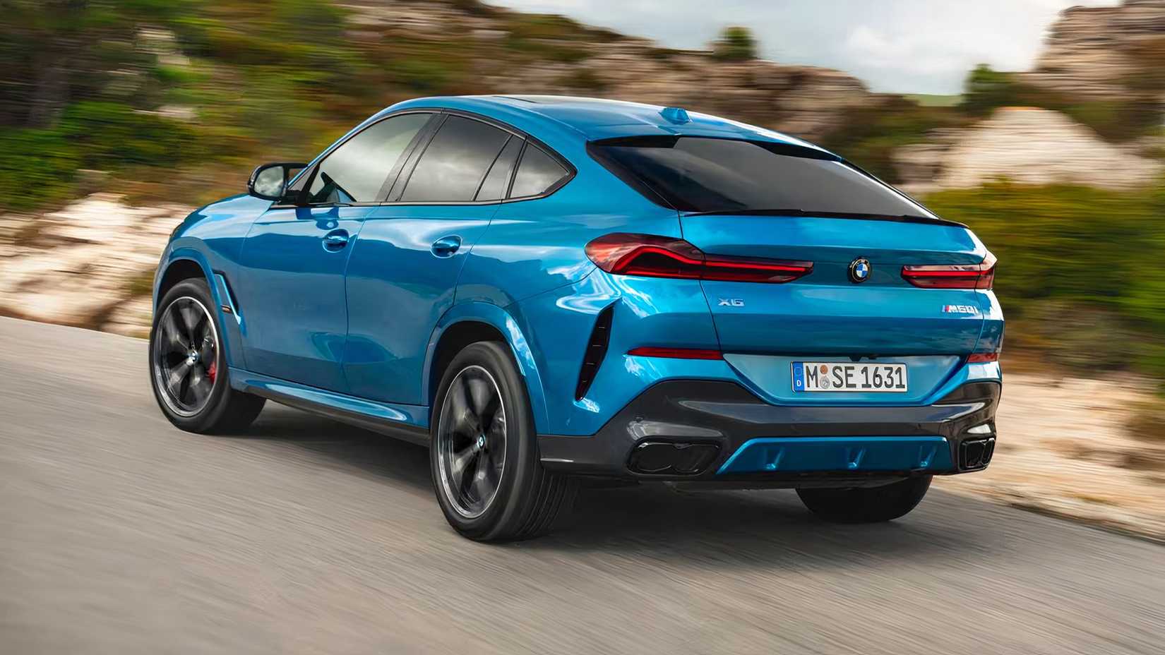 2025 BMW X6 M60i in blue being driven on road