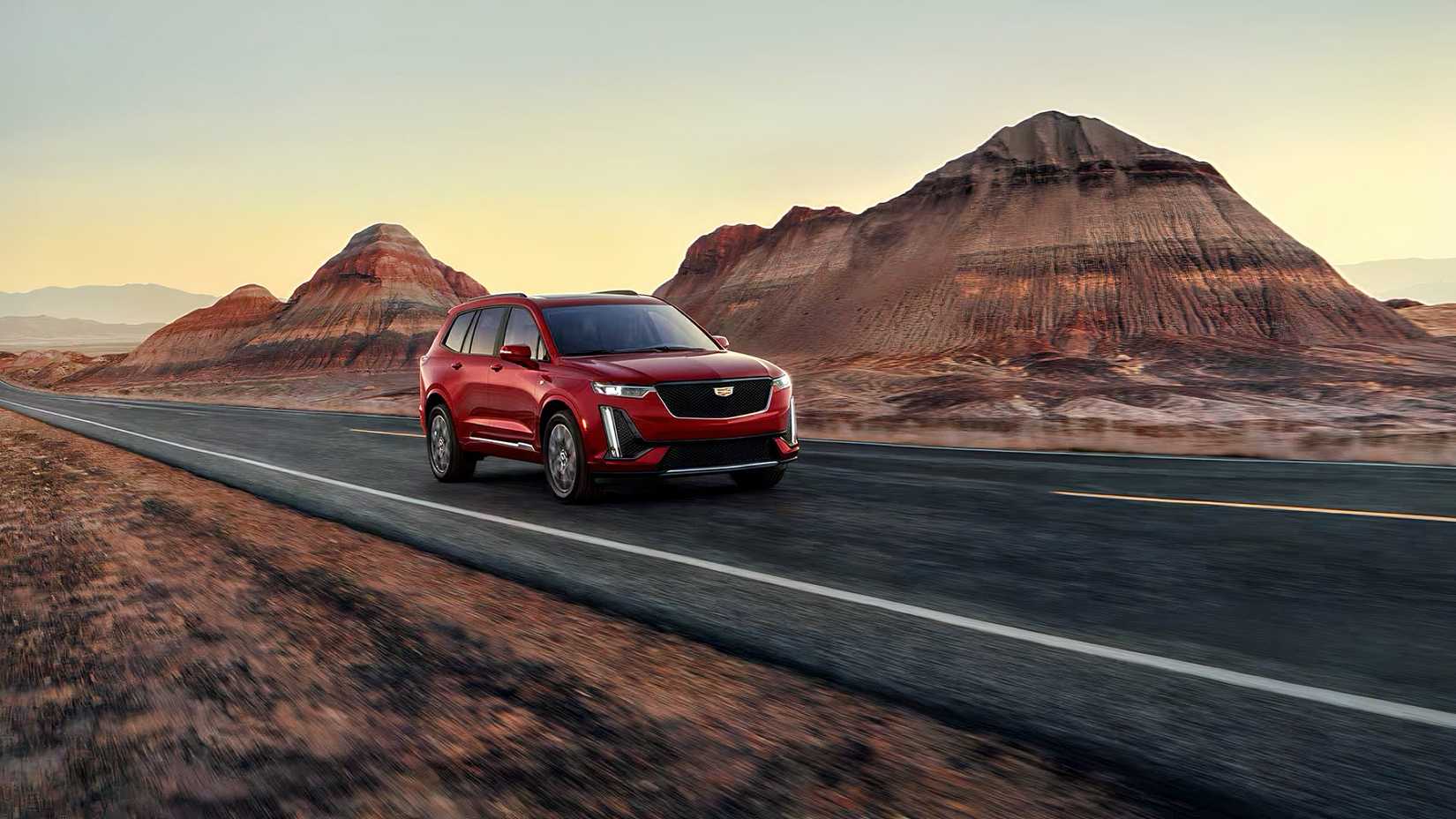 2025 Cadillac XT6 in red being driven on road
