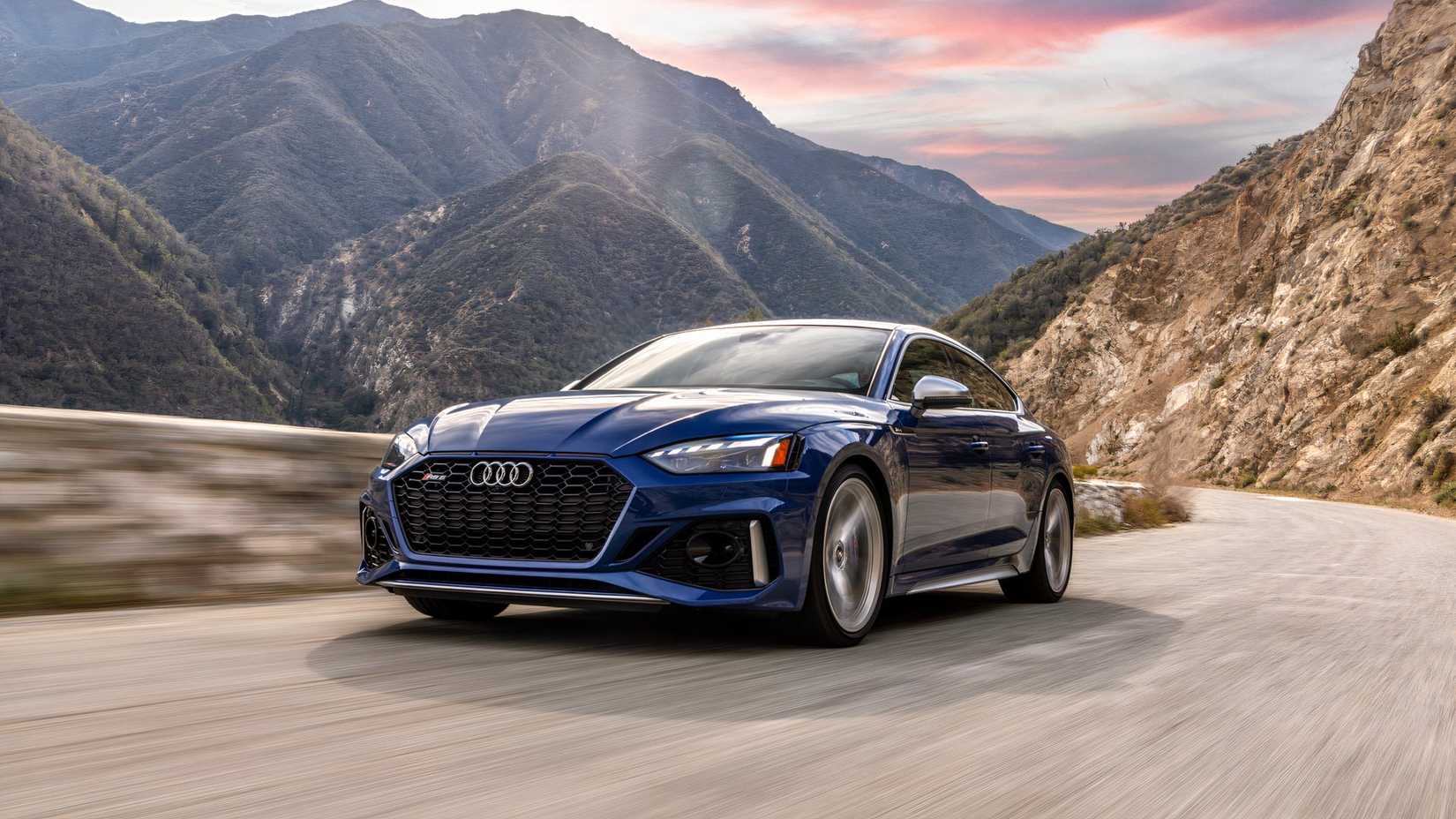 2025 Audi RS5 Sportback in blue being driven on road