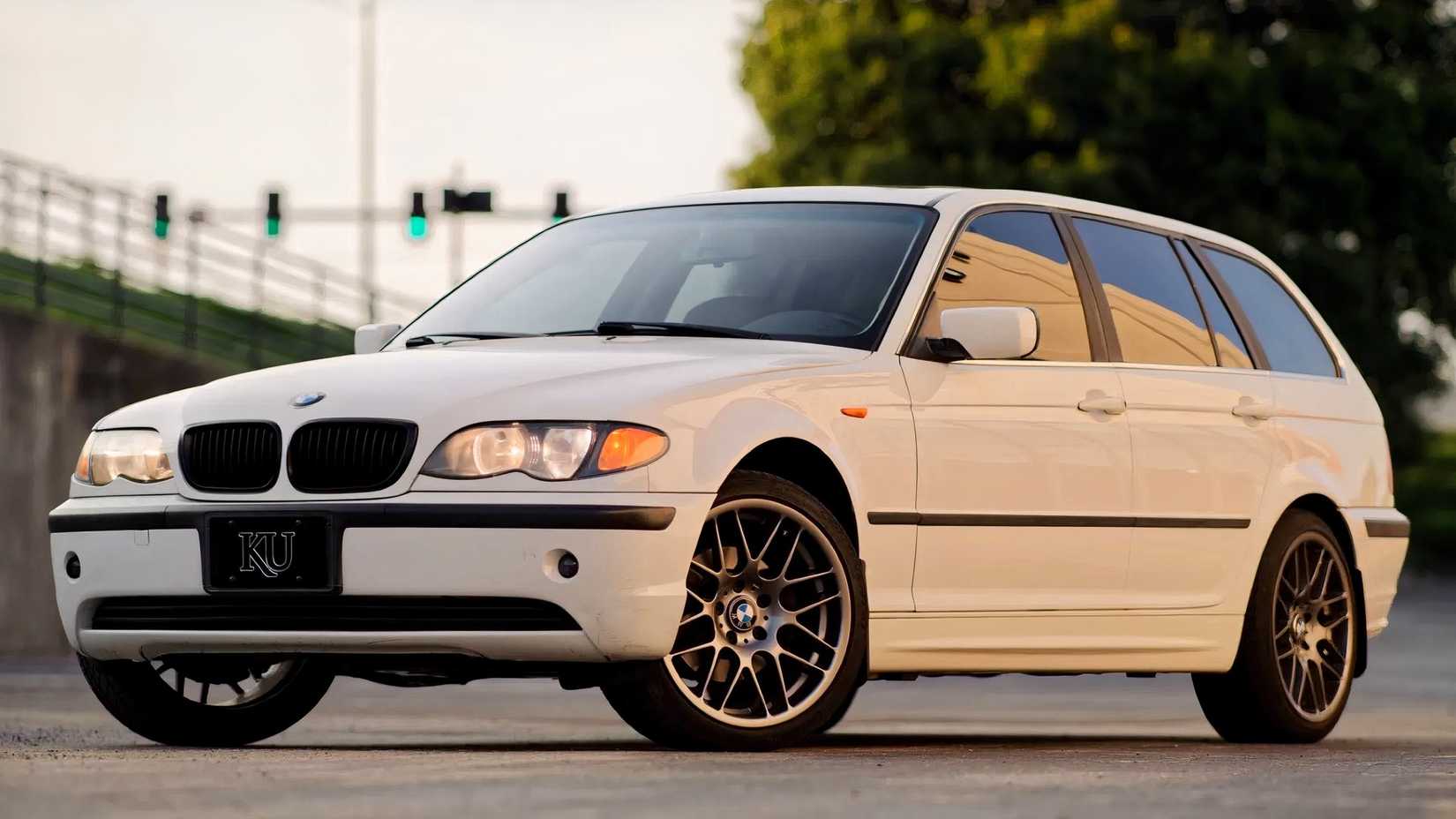 2002 BMW 325i Sport Wagon in white parked