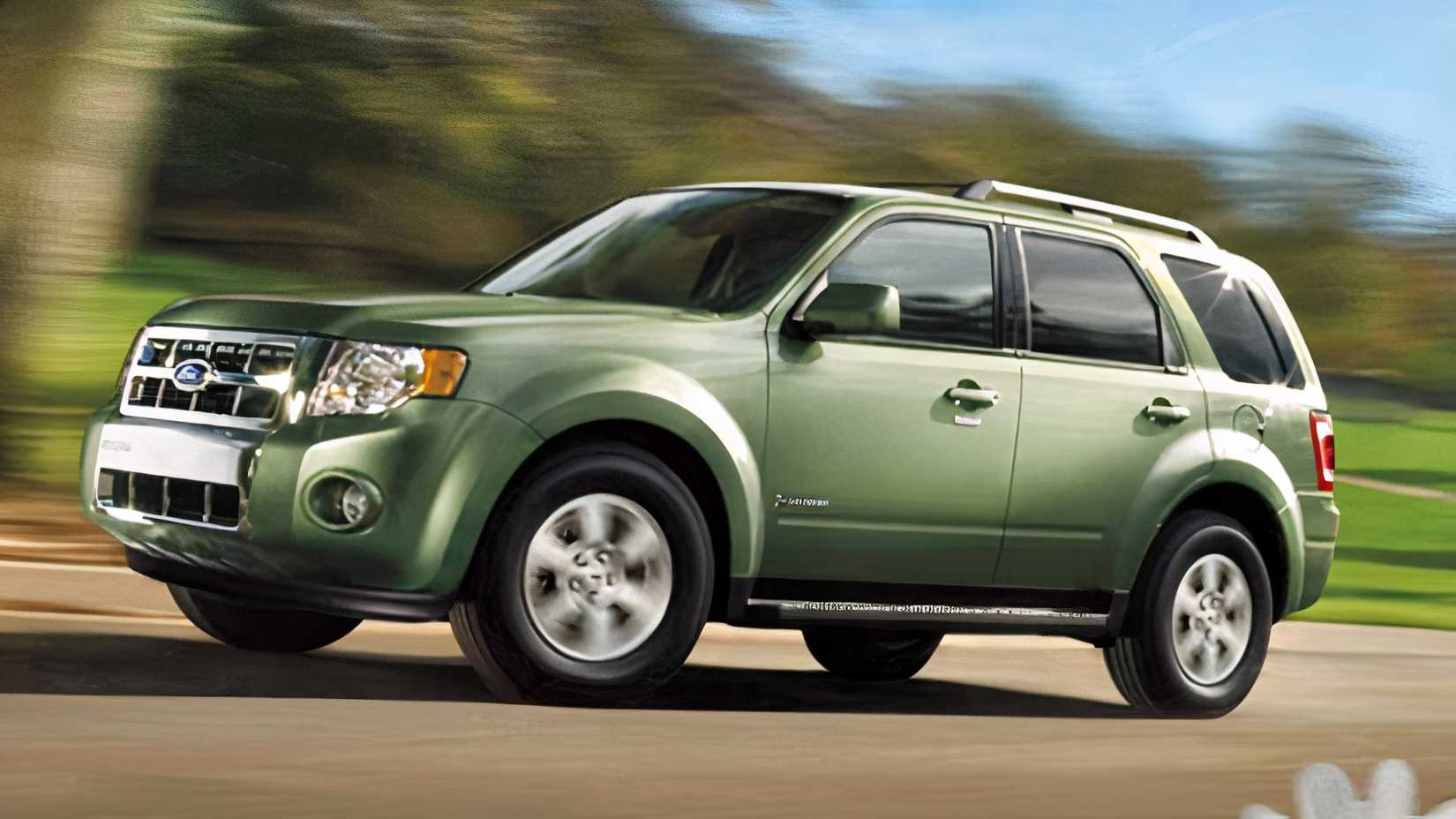 Profile action shot of 2010 Ford Escape Hybrid in green being driven
