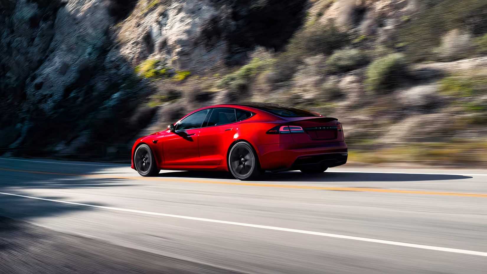 2026 Tesla Model S Plaid in red being driven on road