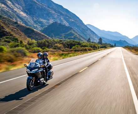 Honda Gold Wing riding two-up, cruising down the highway