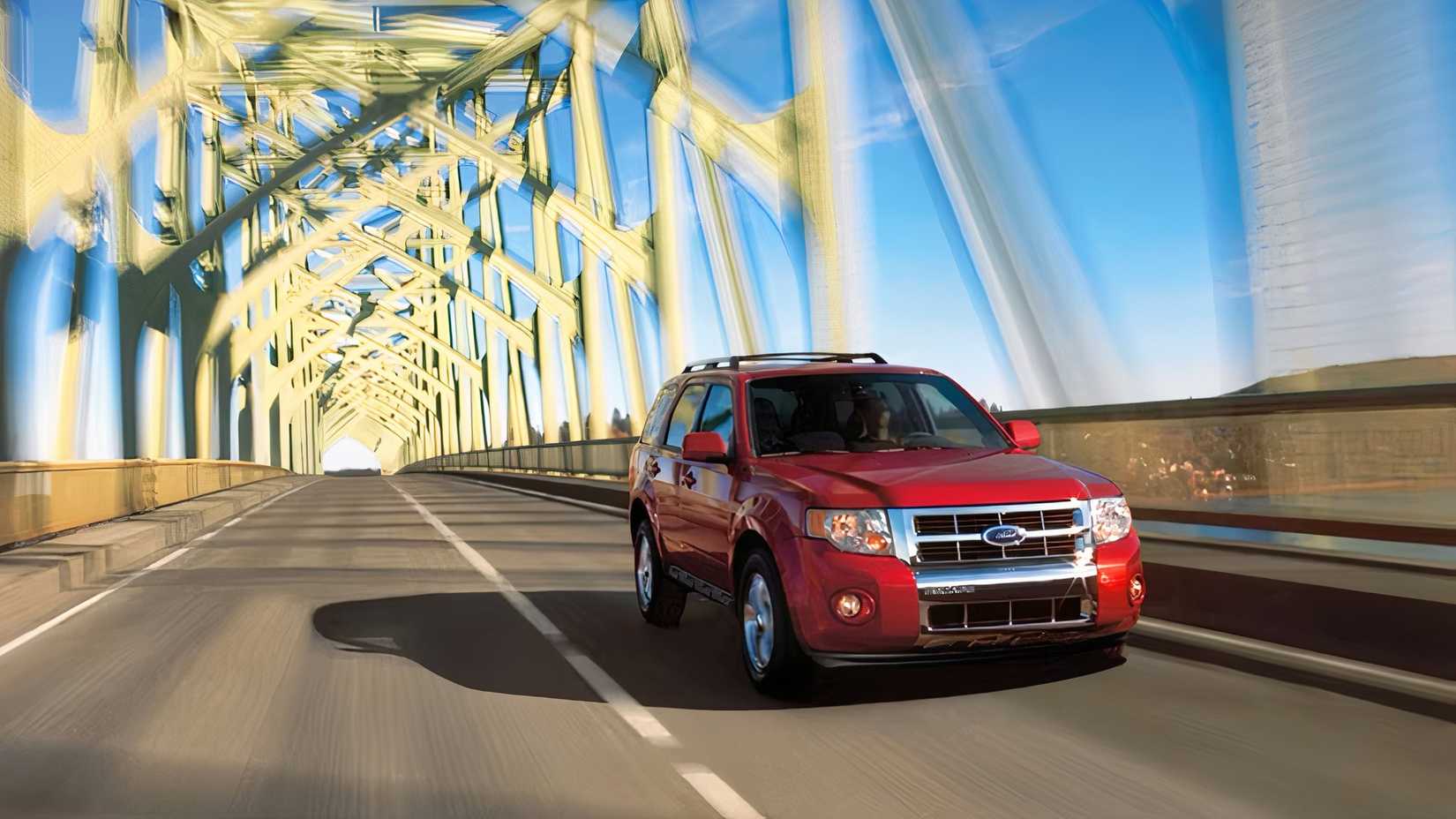 2010 Ford Escape Hybrid front action shot driving on bridge
