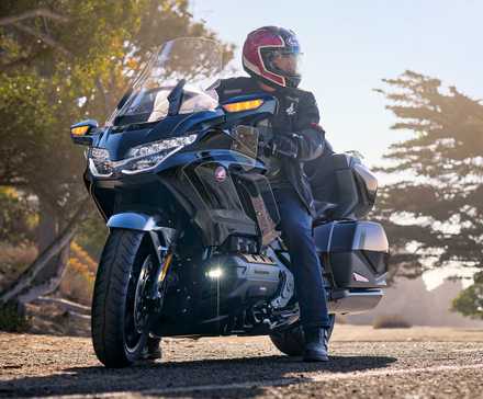 Piloto sentado em uma Honda Gold Wing Tour 2026 em frente a árvores