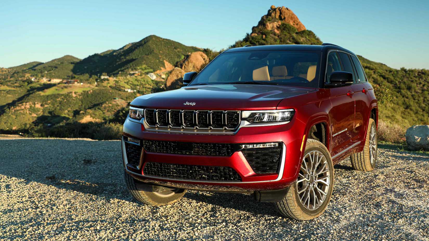 2026 Jeep Grand Cherokee in red parked off-road