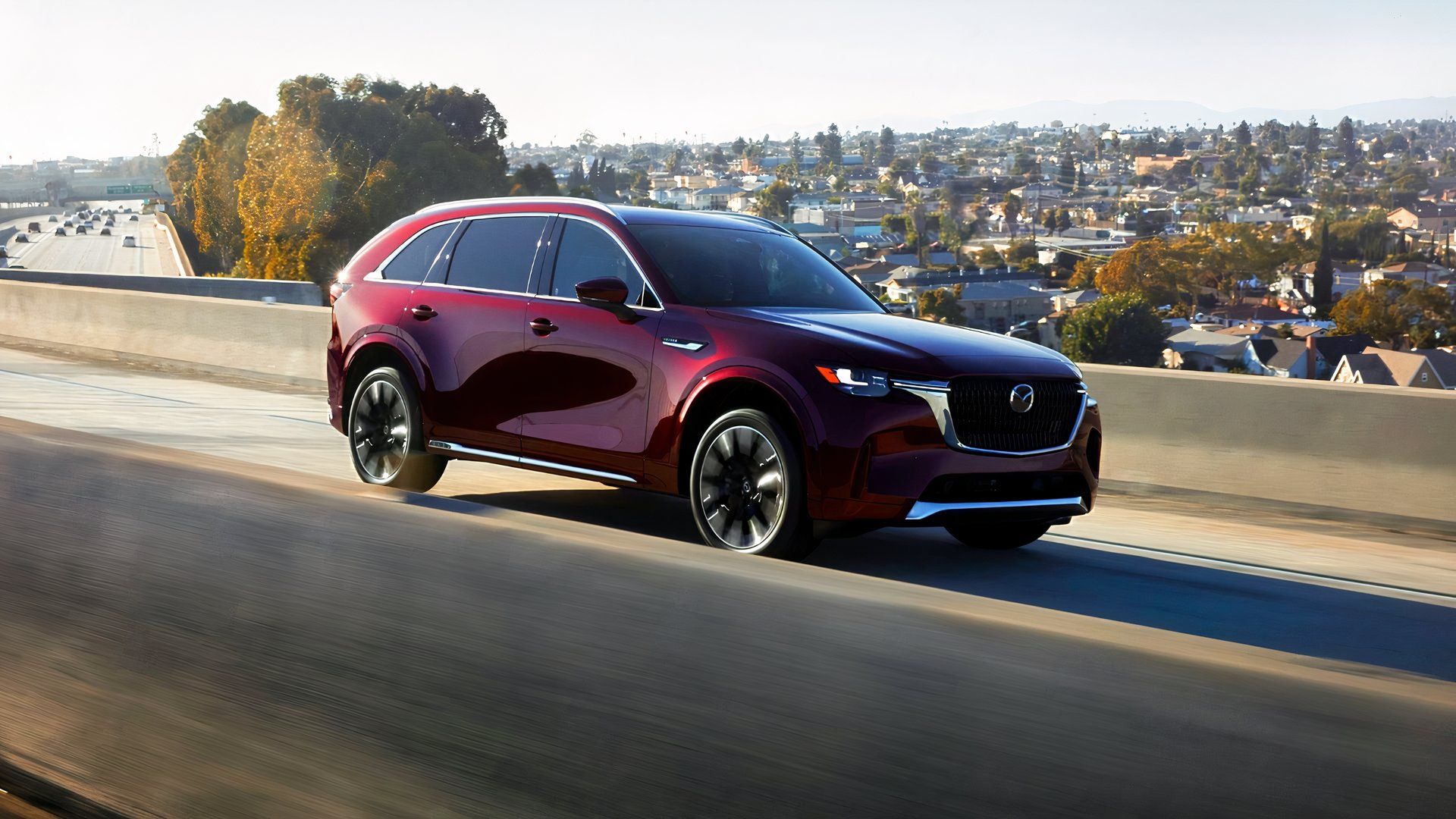 2026 Mazda CX-90 driving front 3/4 view