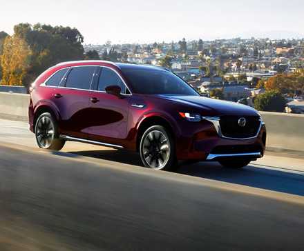 2026 Mazda CX-90 driving front 3/4 view