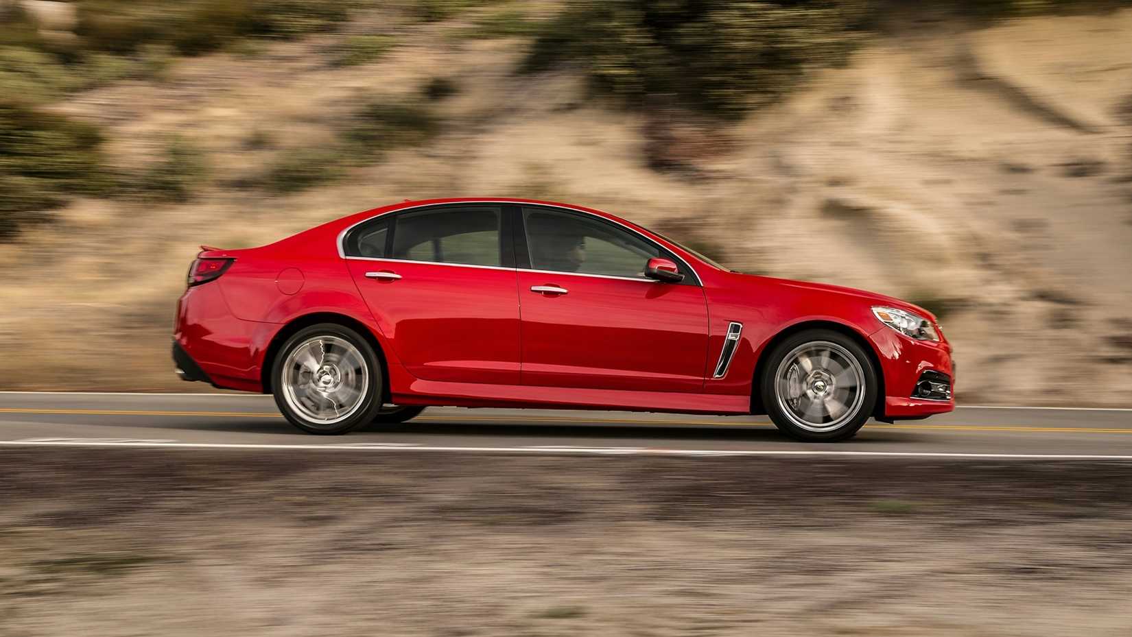 2014 Chevrolet SS in red accelerating side profile view