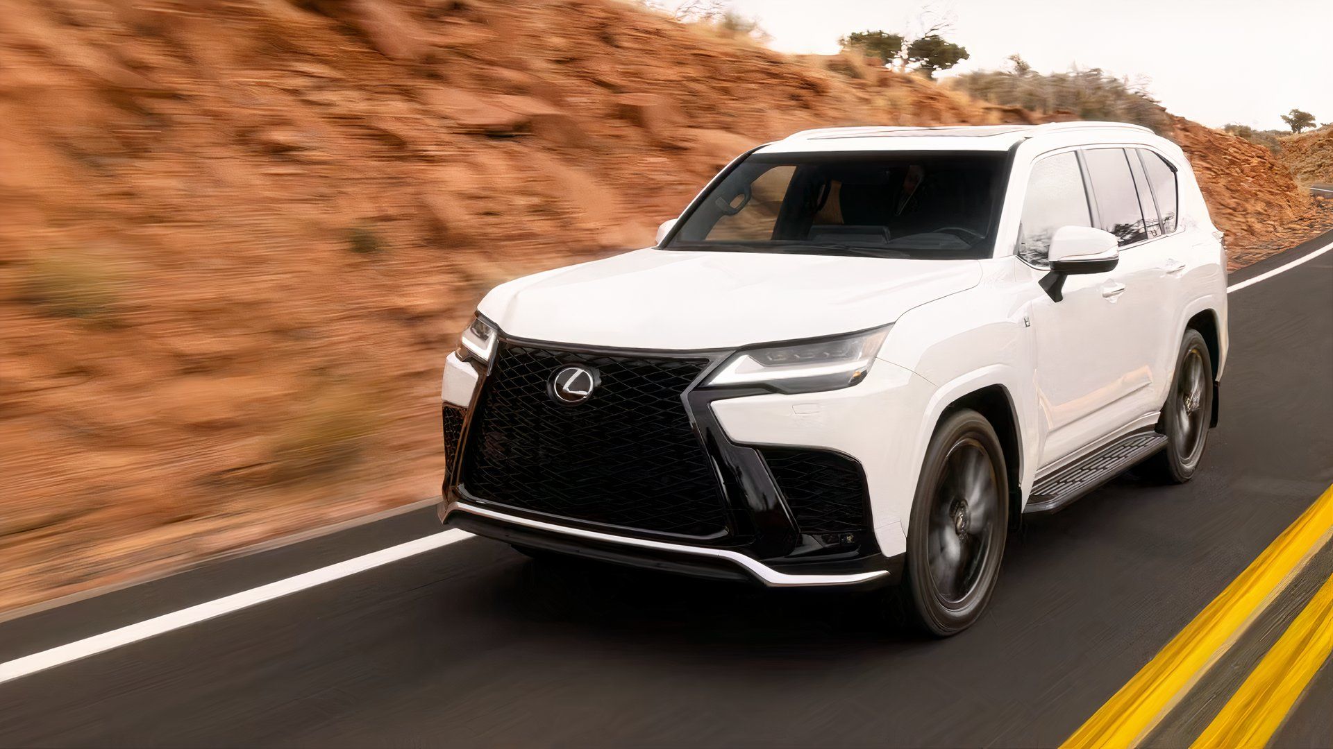 2026 Lexus LX front 3/4 shot driving on the road