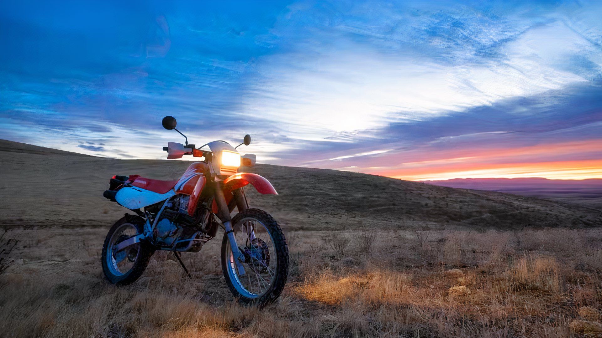 2022 Honda XR650L parked in a field with a great sky in the background