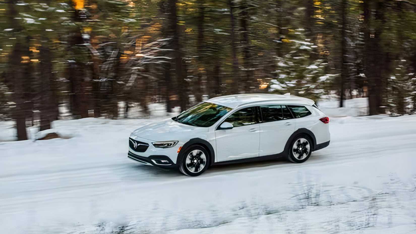 2019 Buick Regal TourX side action shot driving in snow