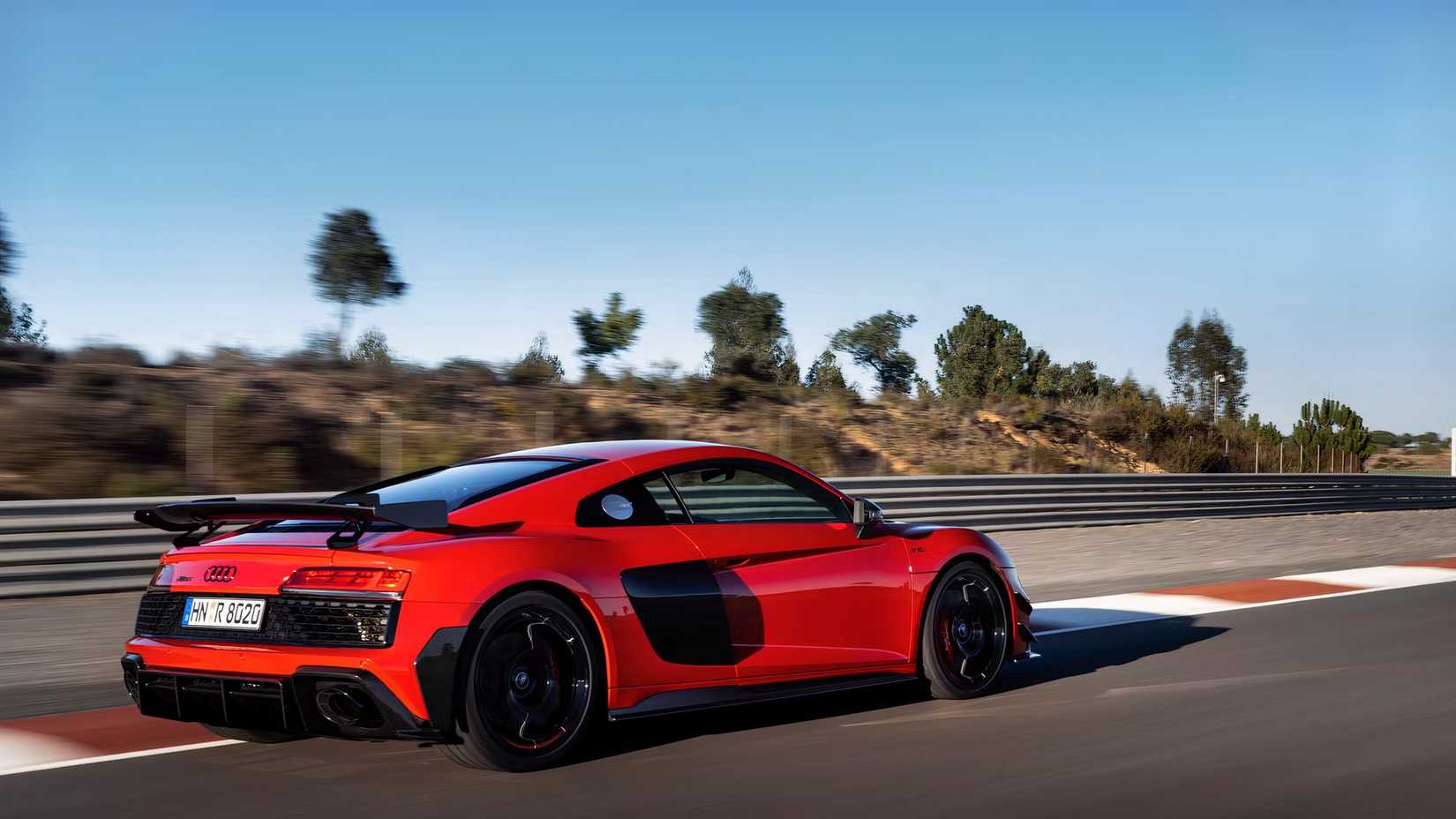 Foto traseira 3/4 de um Audi R8 GT 2023 dirigindo na pista