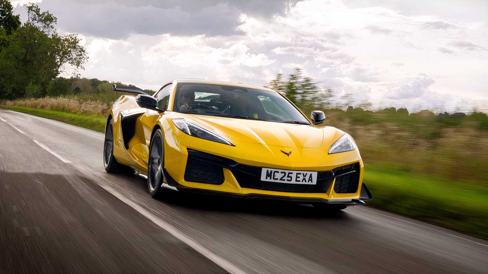 A dynamic front-quarter tracking shot of a yellow 2026 Chevrolet Corvette Z06 RHD.