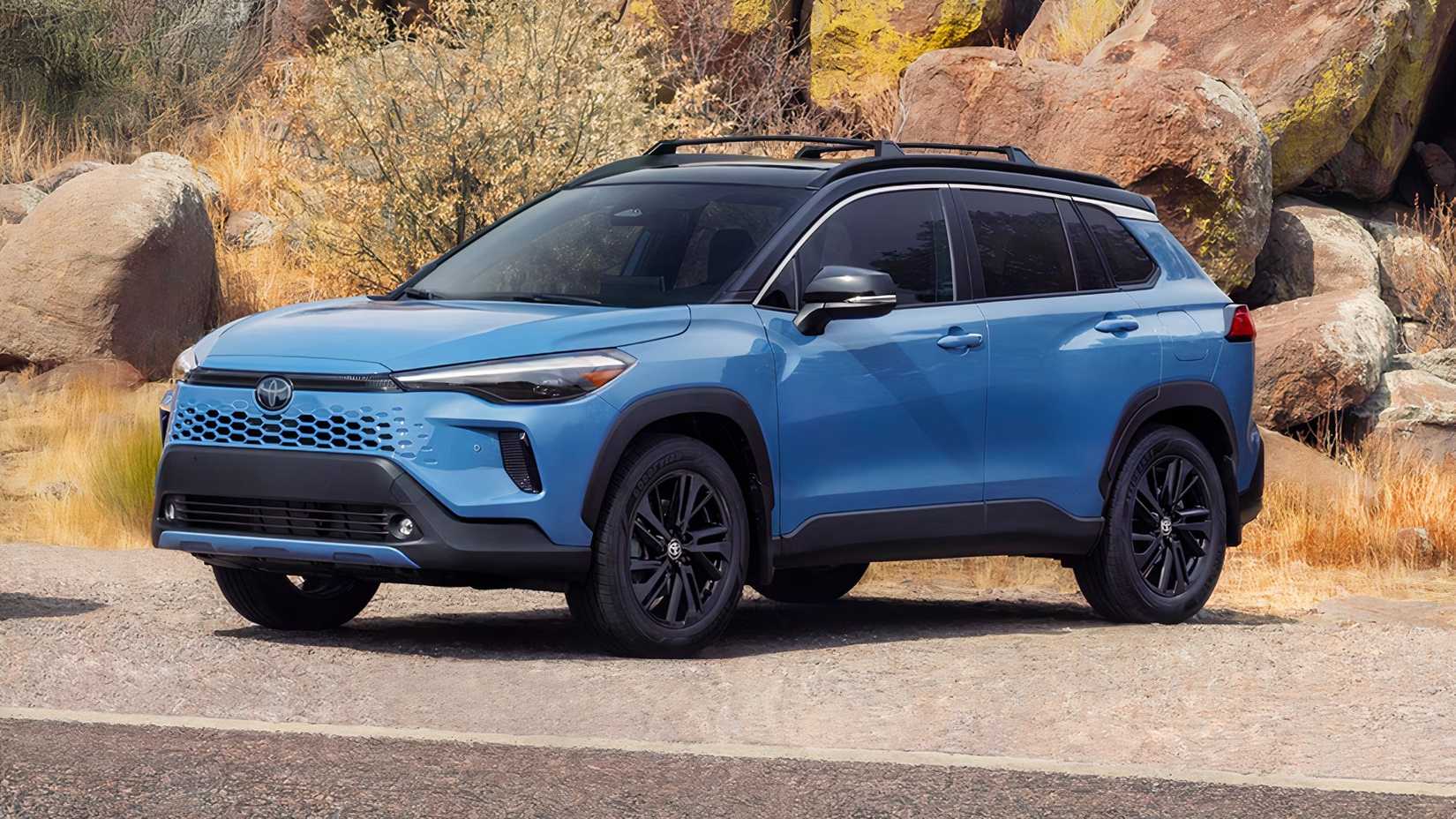 Front 3/4 shot of a 2026 Toyota Corolla Cross Hybrid parked in front of rocks