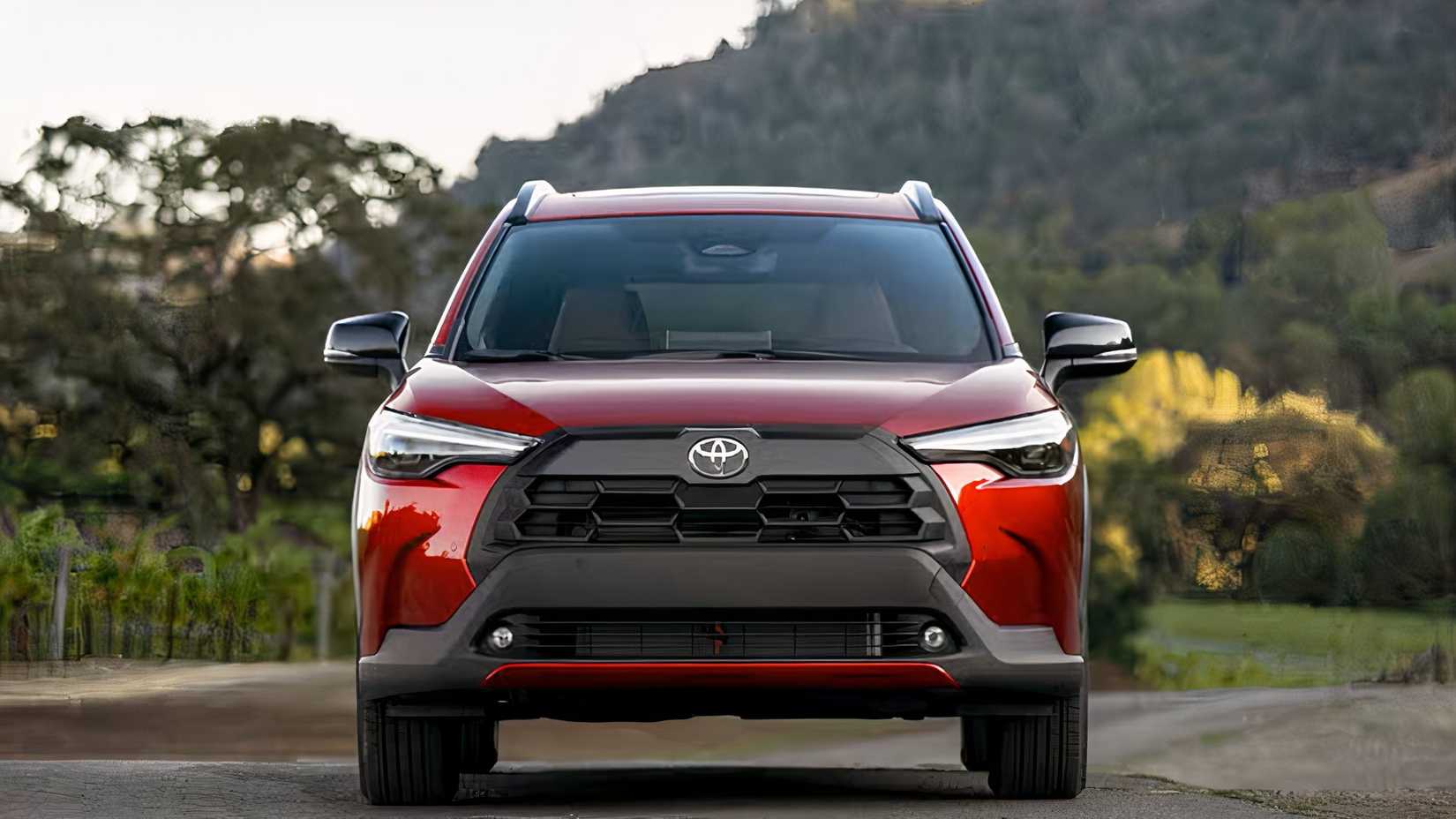 Front shot of a red 2026 Toyota Corolla Cross parked in the street
