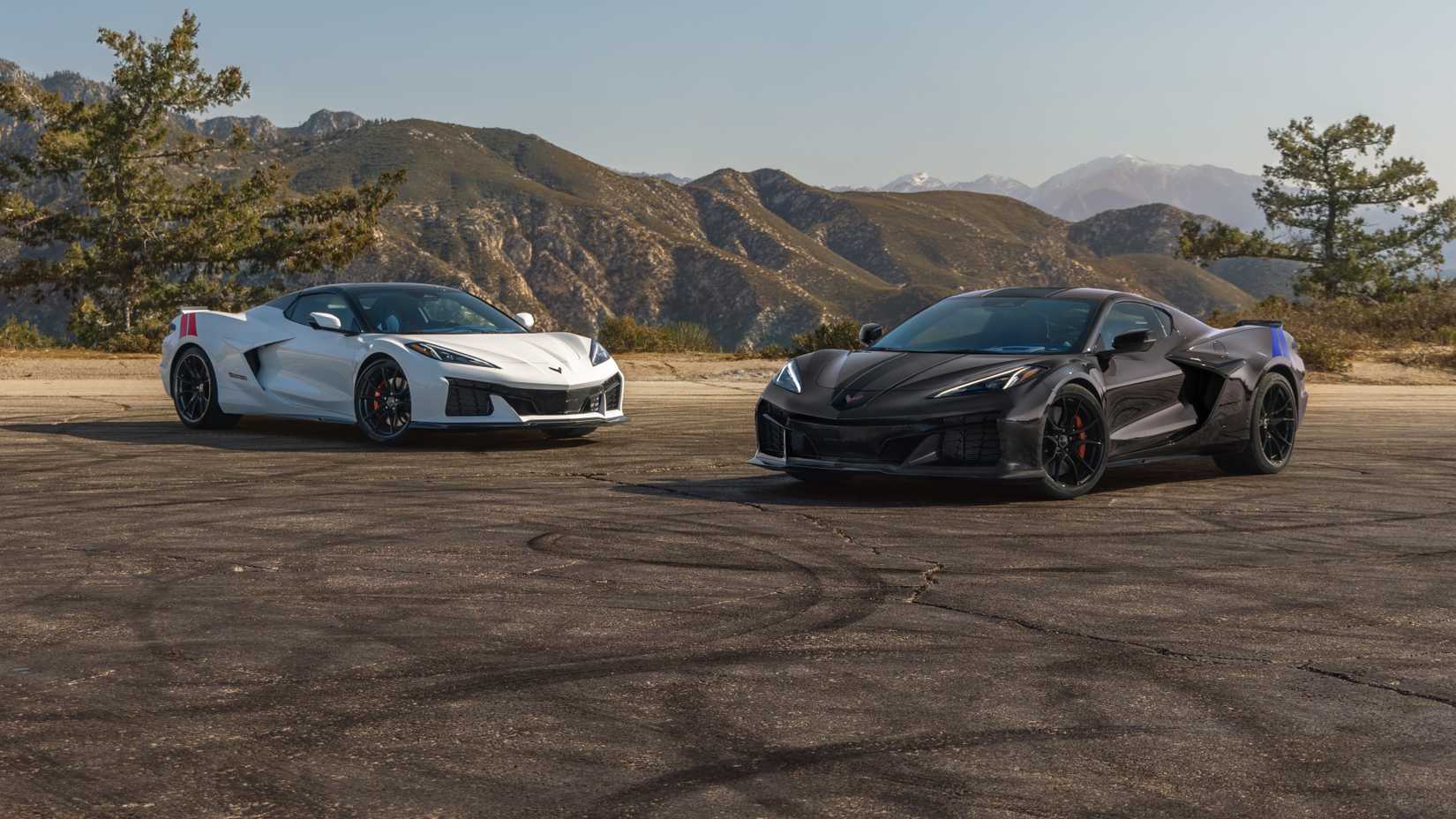 The 2027 Chevrolet Corvette Grand Sport Launch Edition in Arctic White and Grand Sport X in Pitch Gray Metallic positioned side by side