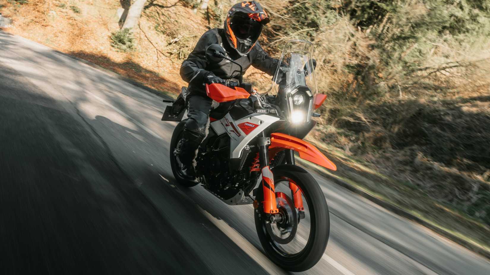 2026 KTM 390 Adventure X cornering fast on tarmac front third quarter cinematic shot