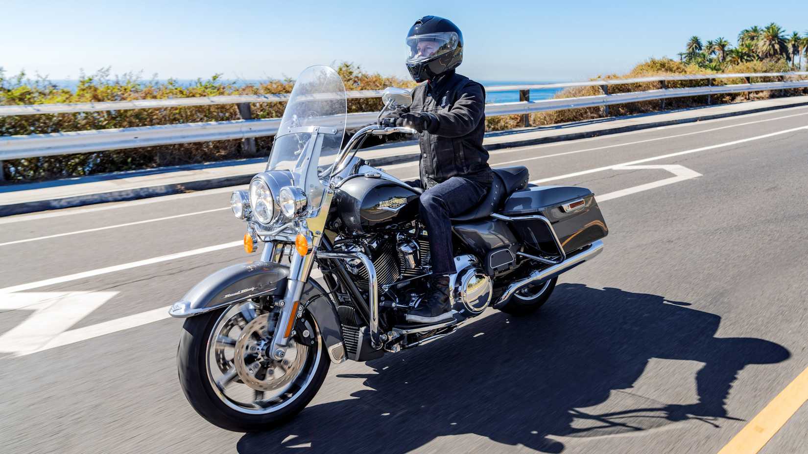 Rider on a 2022 Harley-Davidson Road King cruising on the highway