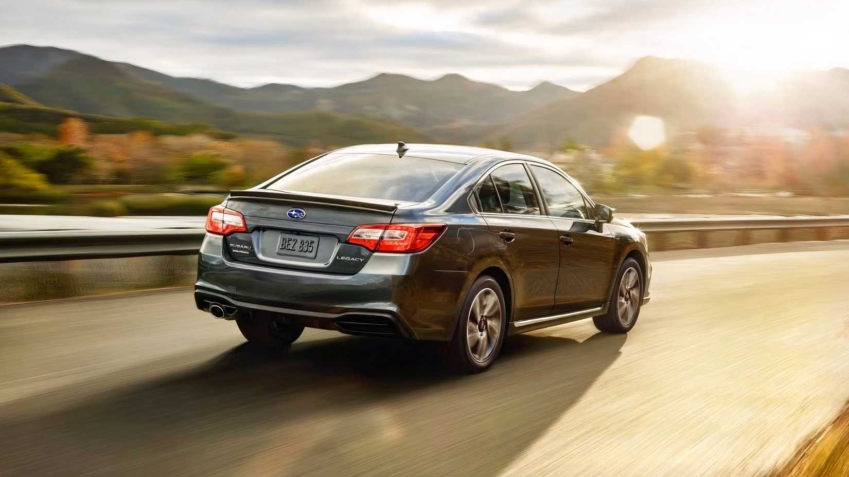Rear driving shot of a 2018 Subaru Legacy driving along scenic road