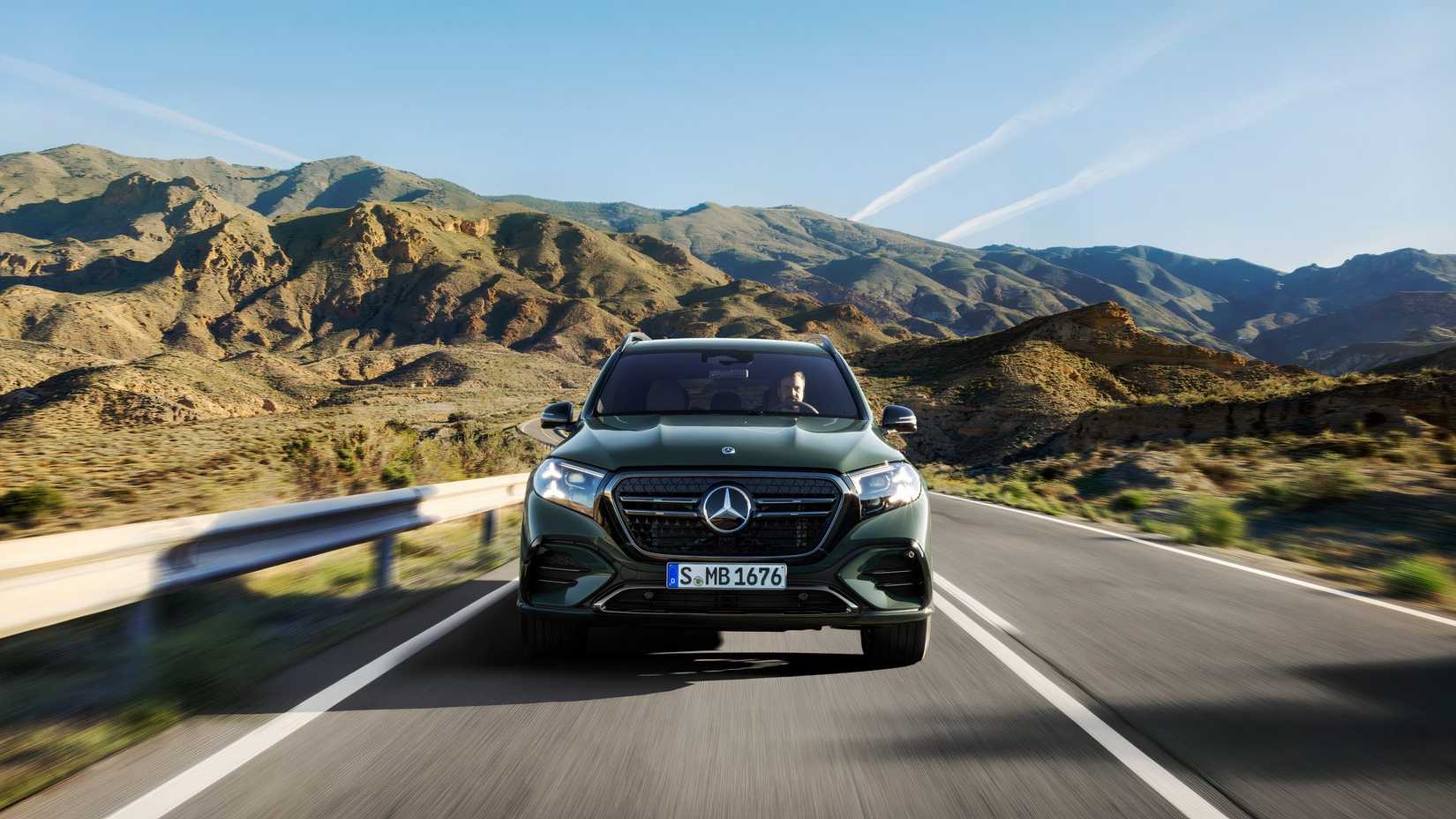 Front shot of a green 2027 Mercedes-Benz GLS driving down road