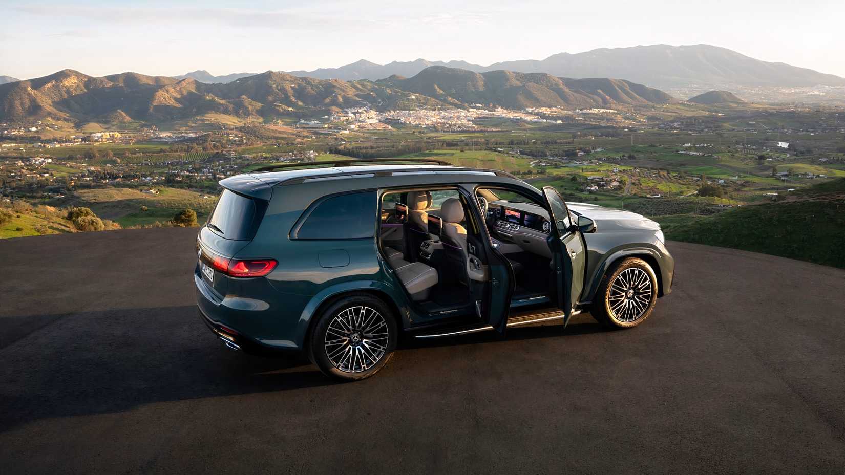 Vista lateral de um Mercedes-Benz GLS 2027 verde com portas abertas