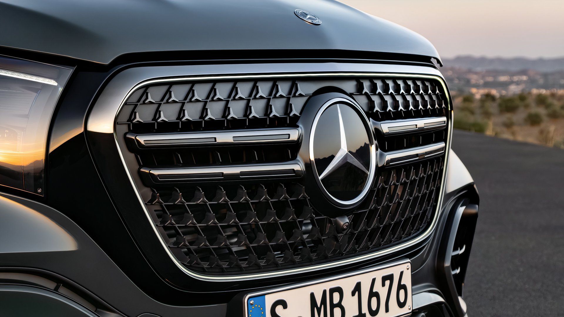 Front close-up of a green 2027 Mercedes-Benz GLS's grille