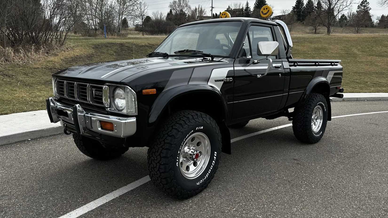 The front 3/4 view of a black 1981 Toyota Pickup SR-5 4×4 5-Speed.