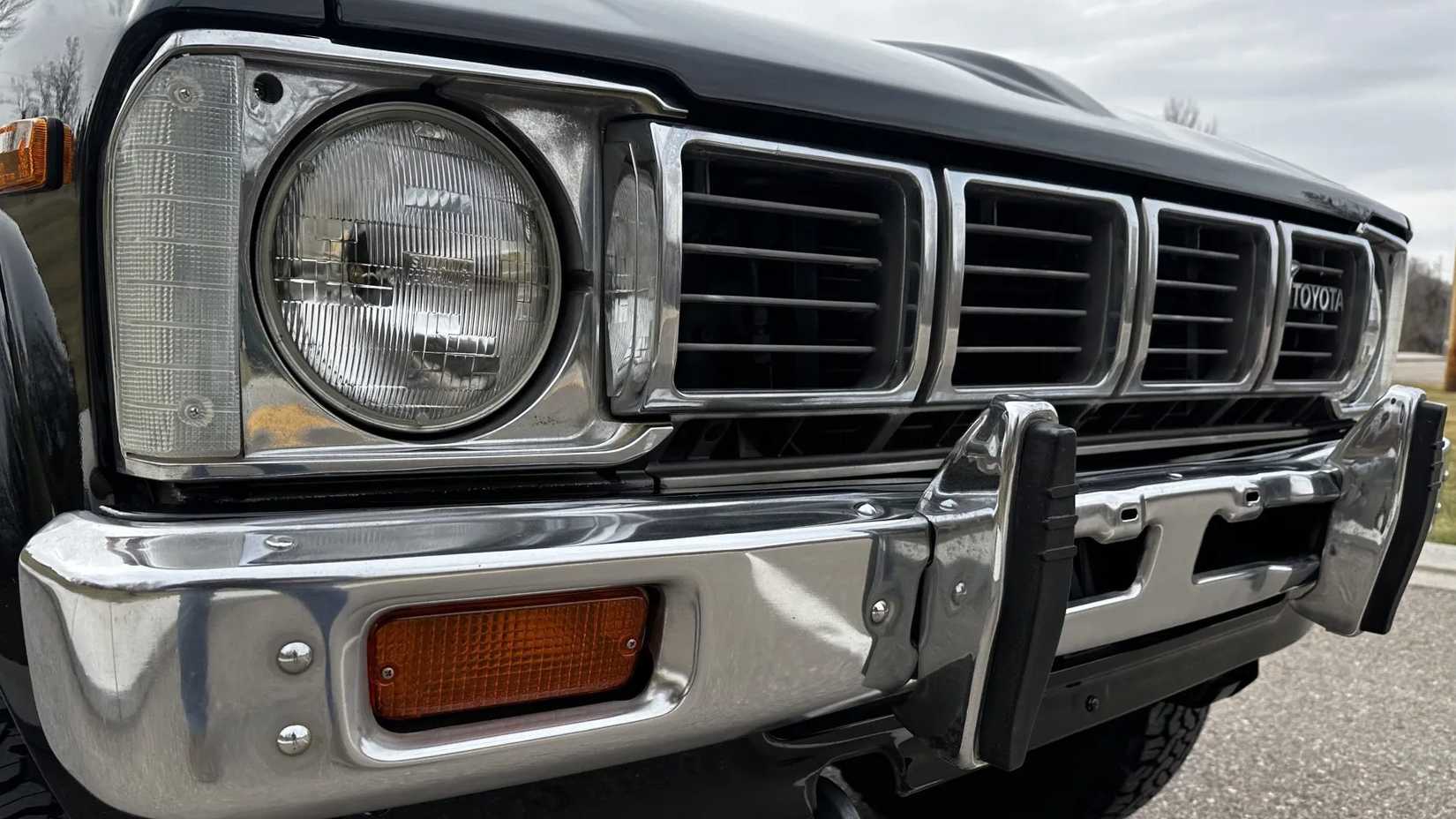 A close-up shot of the front end of a black 1981 Toyota Pickup SR-5 4×4 5-Speed