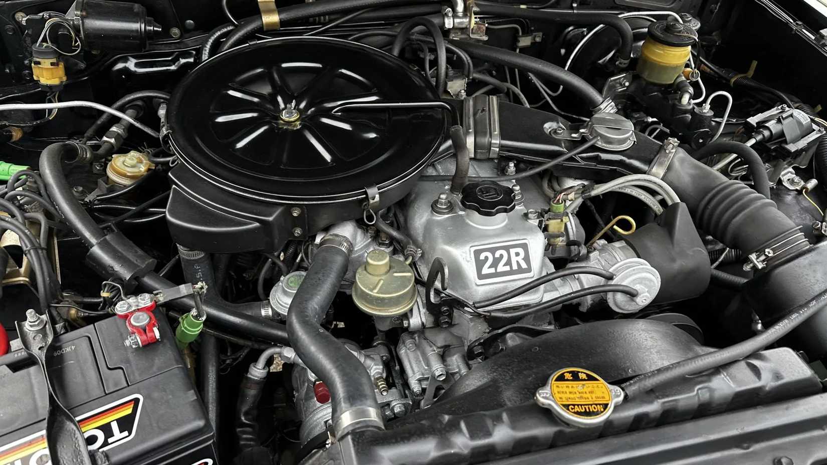The 22R engine of a black 1981 Toyota Pickup SR-5 4×4 5-Speed