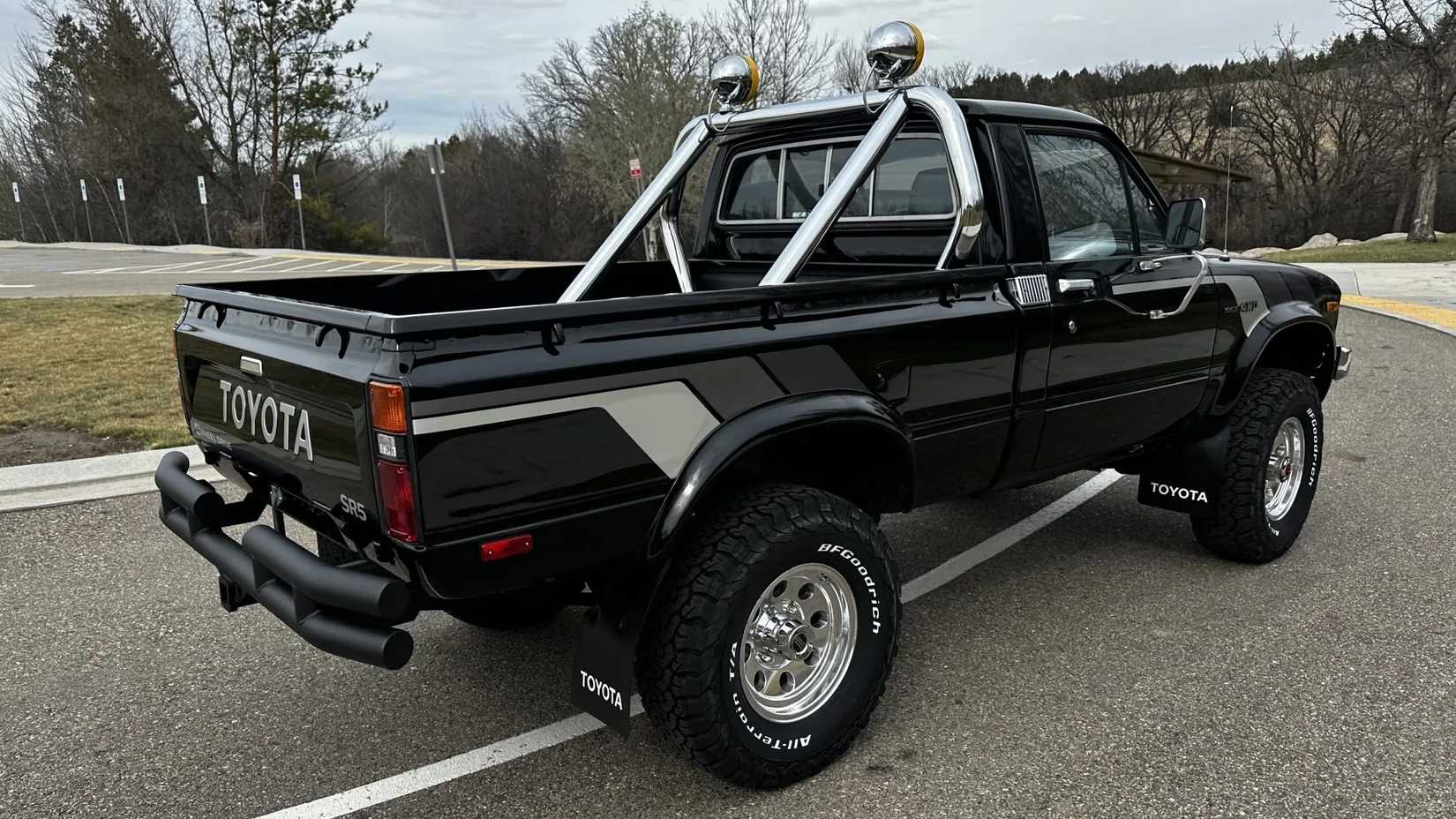 The rear 3/4 view of a black 1981 Toyota Pickup SR-5 4×4 5-Speed