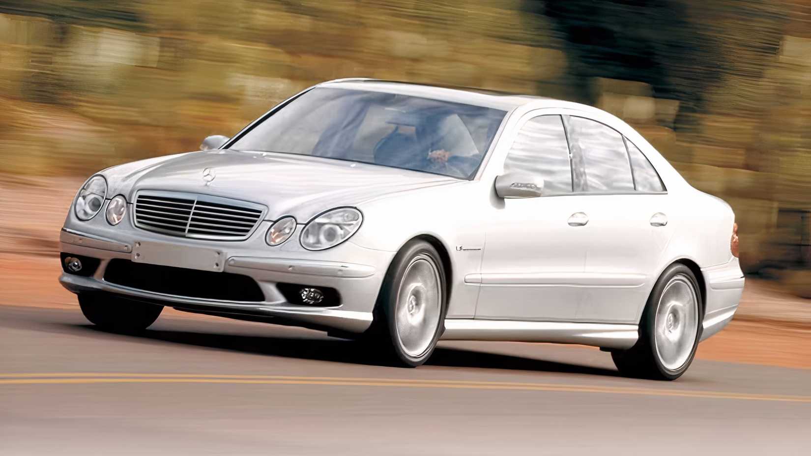 Front 3/4 shot of a 2003 Mercedes-Benz E55 AMG driving down the road