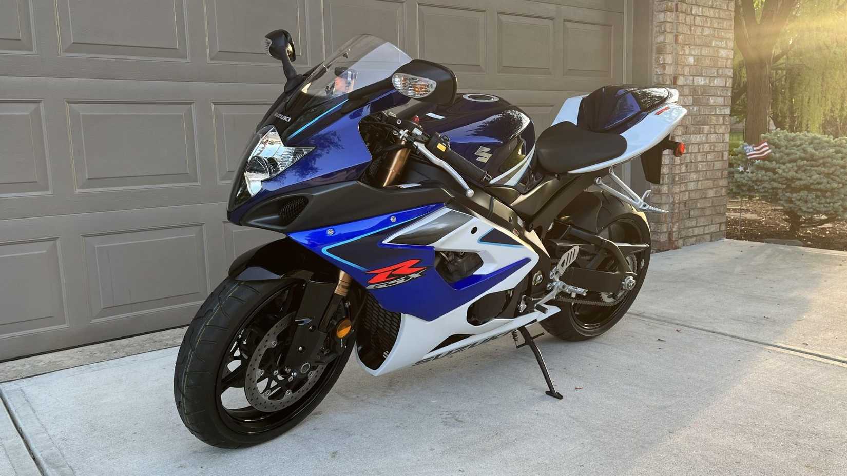 2005 Suzuki GSX-R 1000 parked in front of a garage front third quarter view