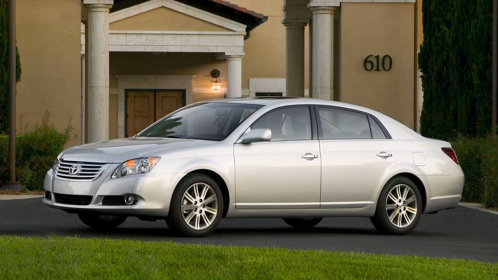 Silver 2009 Toyota Avalon Posed In Front Of A Home