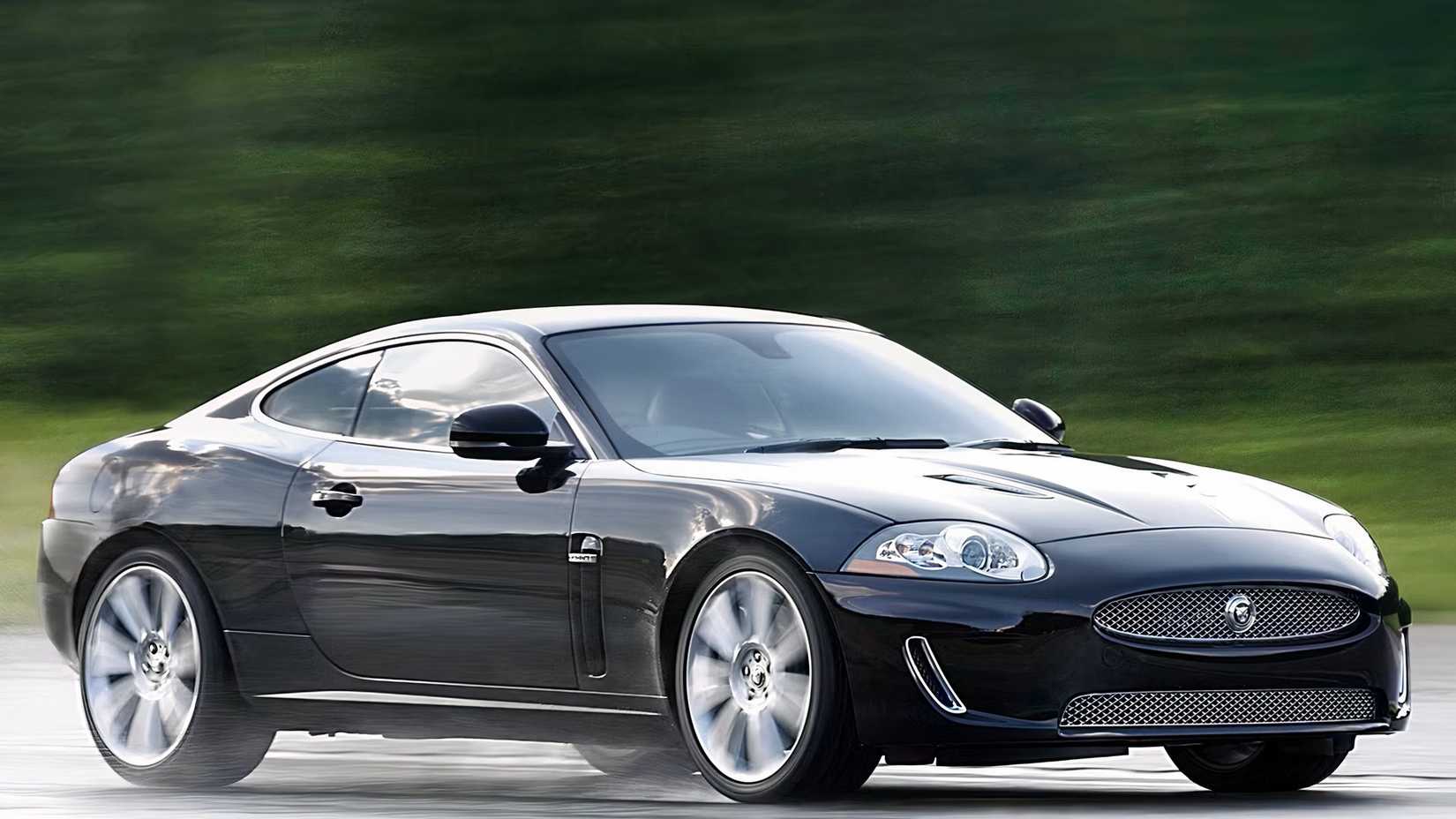 A 2010 Jaguar XKR kicks up water on a wet road