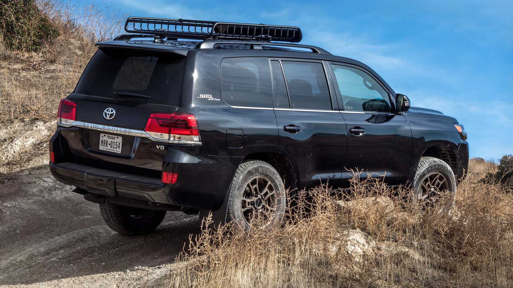 2021 Toyota Land Cruiser rear shot driving on off-road trail
