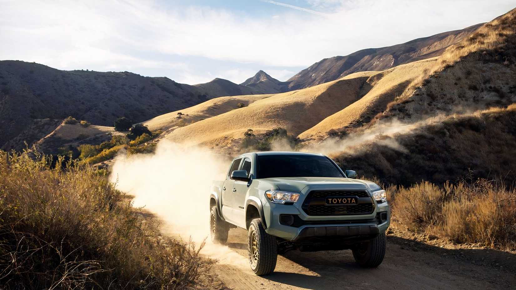 Front shot of a 2022 Toyota Tacoma traveling on dirt road