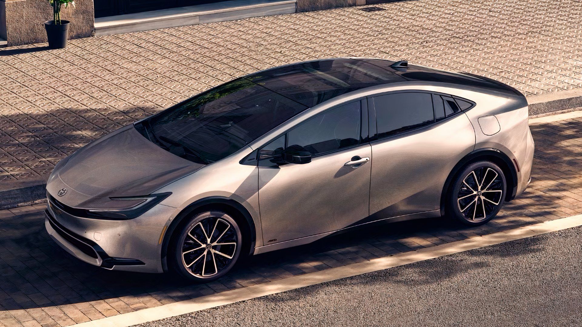 Side shot of a silver 2023 Toyota Prius parked on the street