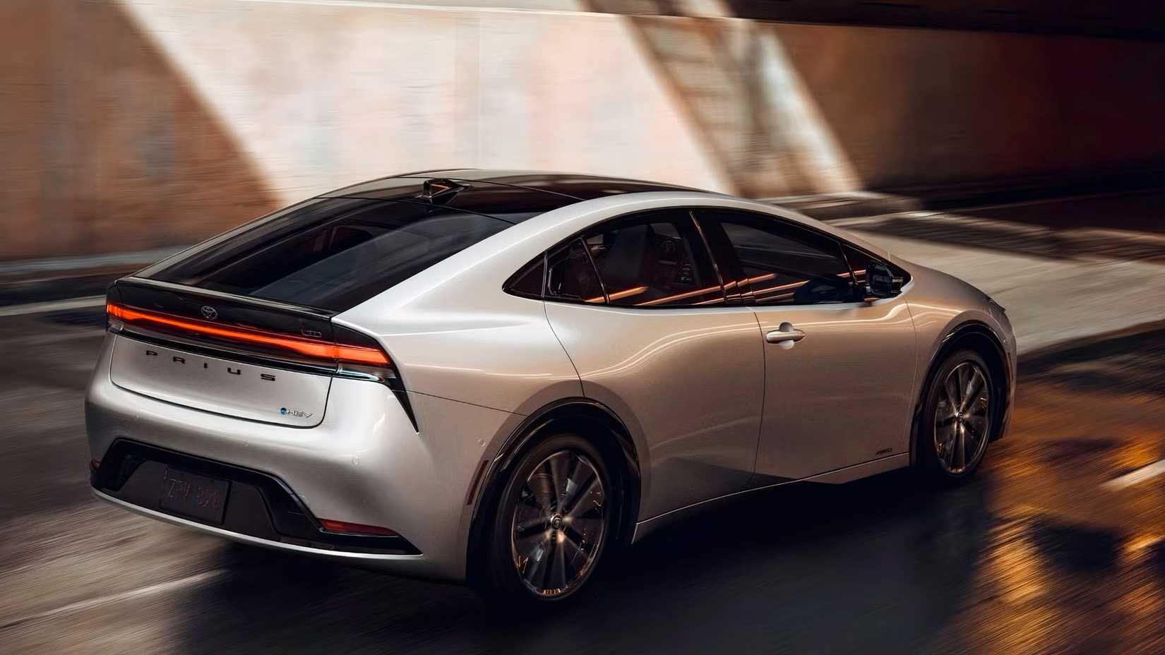 Rear 3/4 shot of a 2023 Toyota Prius driving down the road
