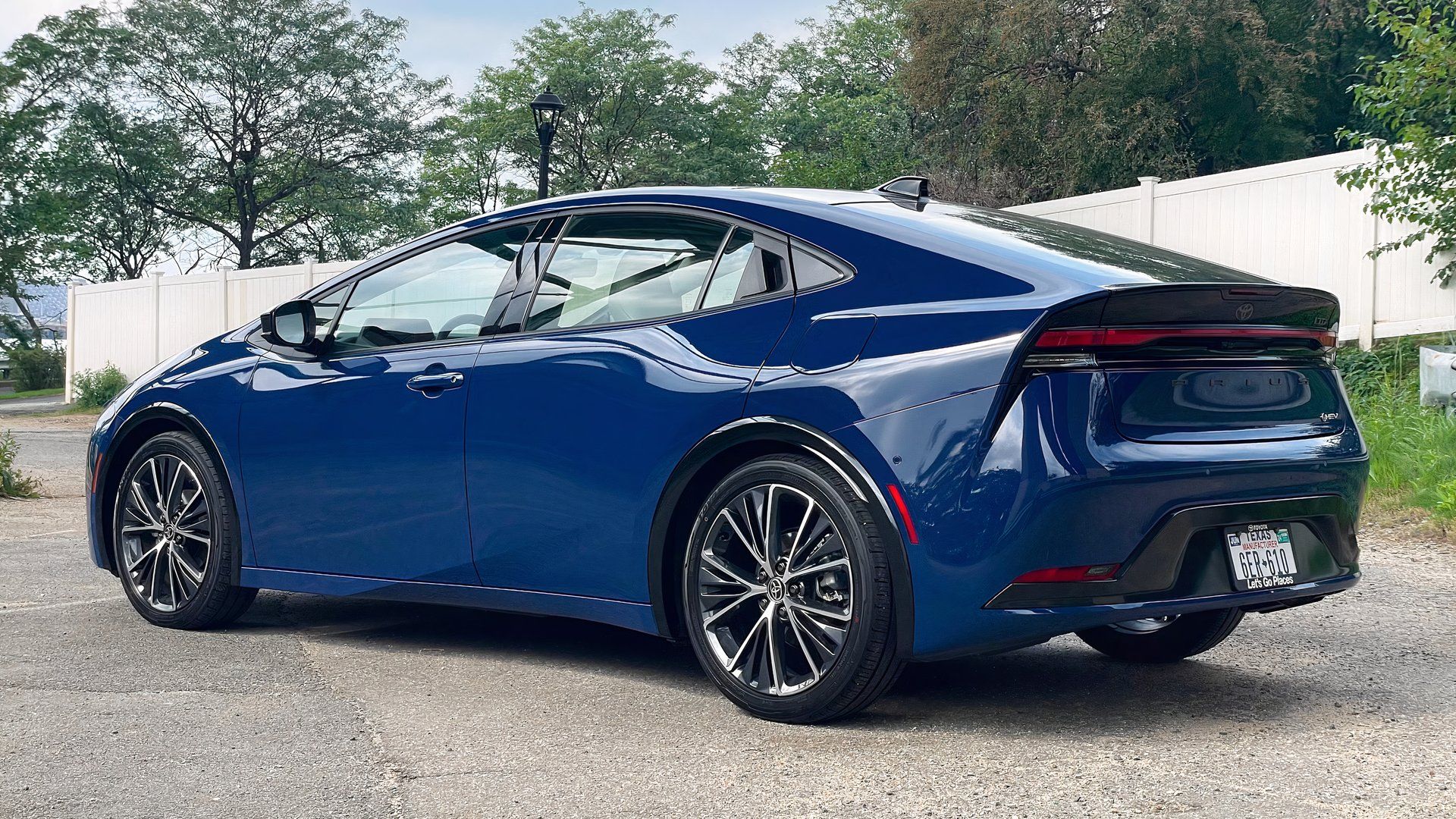 Rear 3/4 shot of a 2023 Toyota Prius parked in the lot