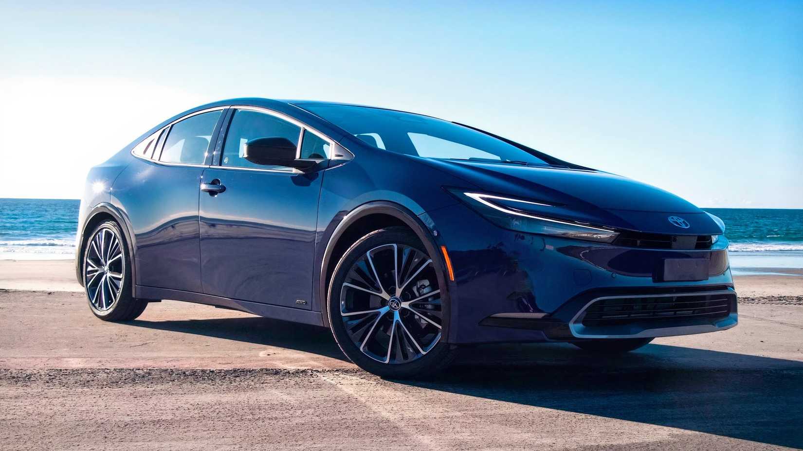 Front 3/4 shot of a 2023 Toyota Prius parked in front of water