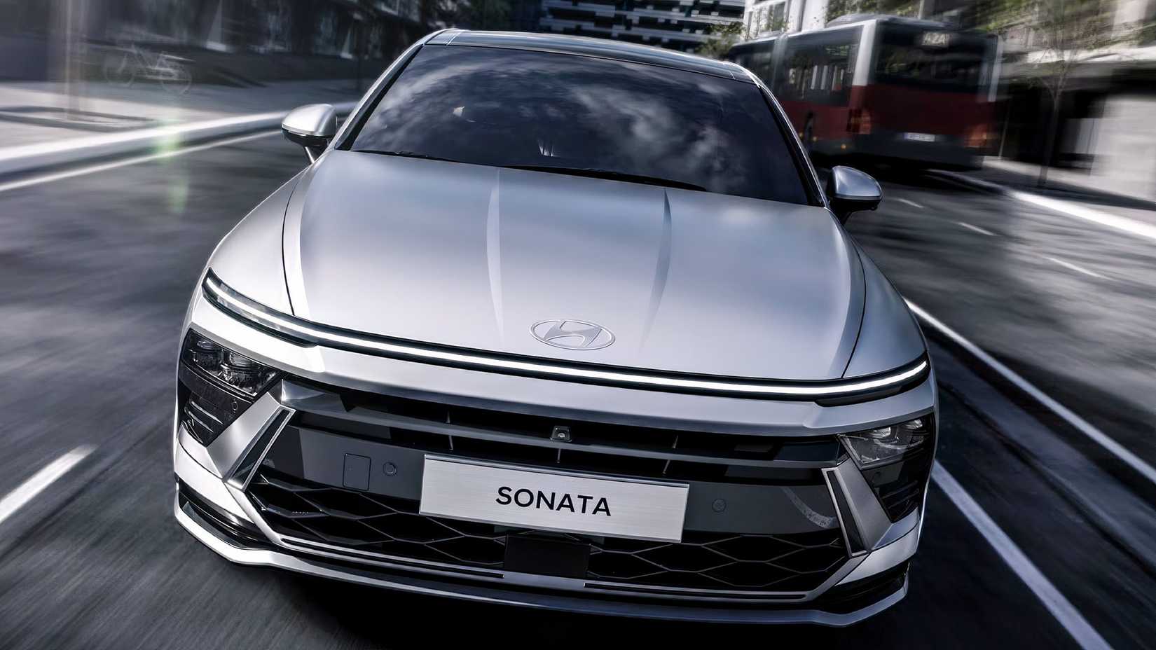 Frotn shot of a 2026 Hyundai Sonata Hybrid driving down the highway