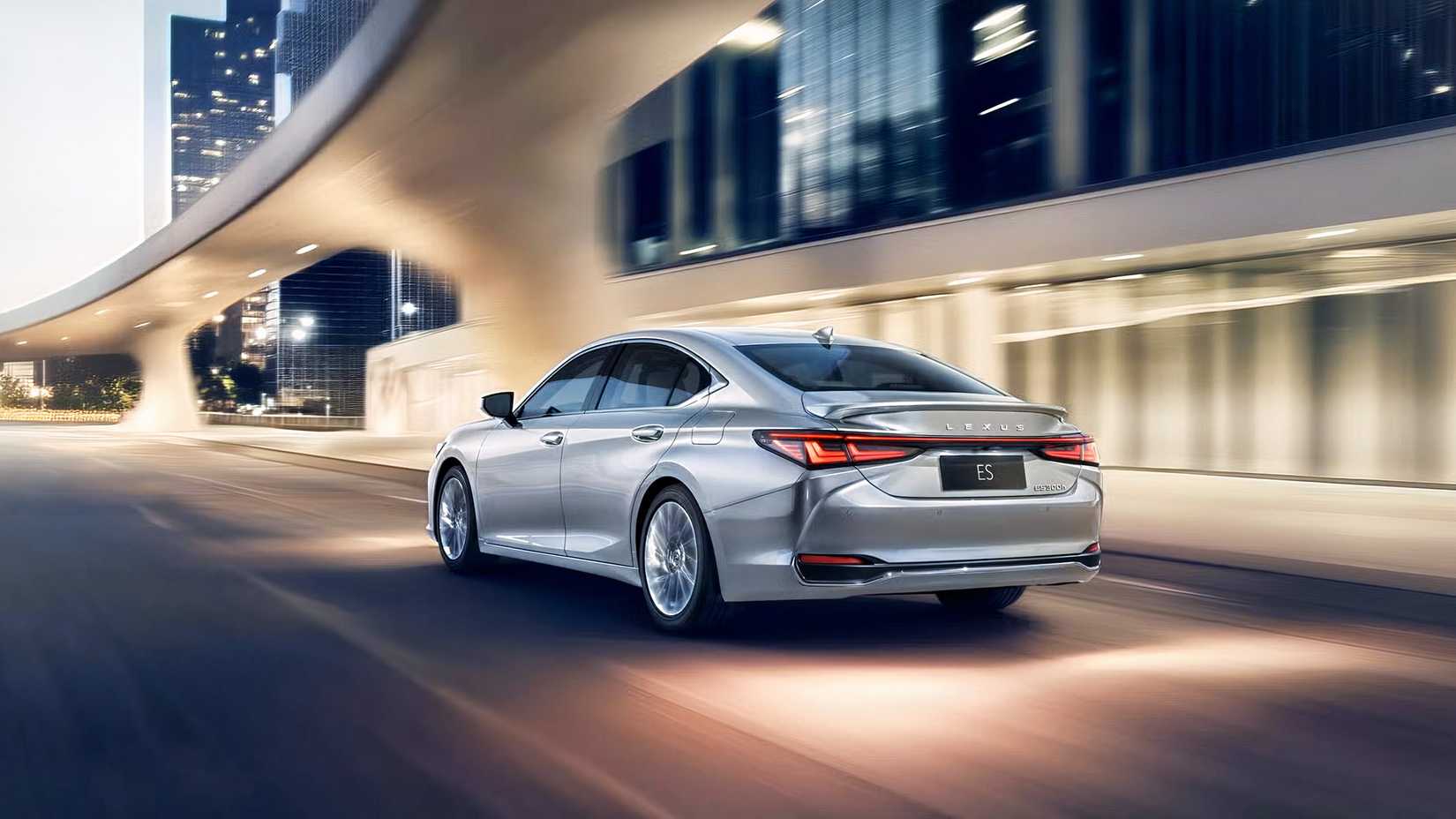 Rear 3/4 View Of A Silver 2025 Lexus ES 300h Driving