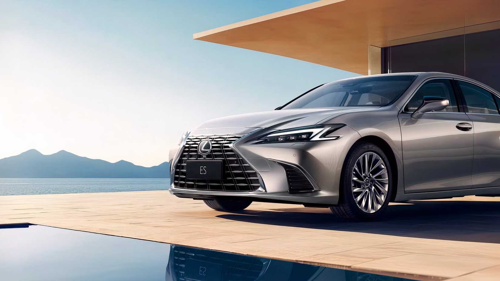 Silver 2026 Lexus ES 300h front shot by a pool