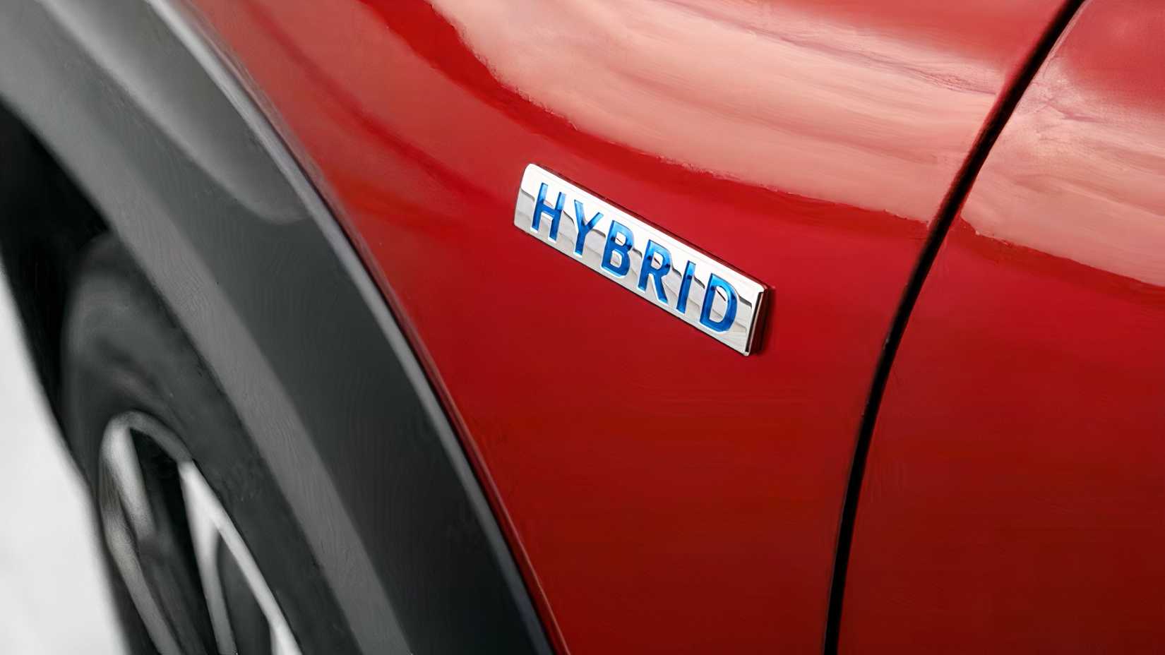 Close-up shot of a red 2026 Mazda CX-50 Hybrid's emblem