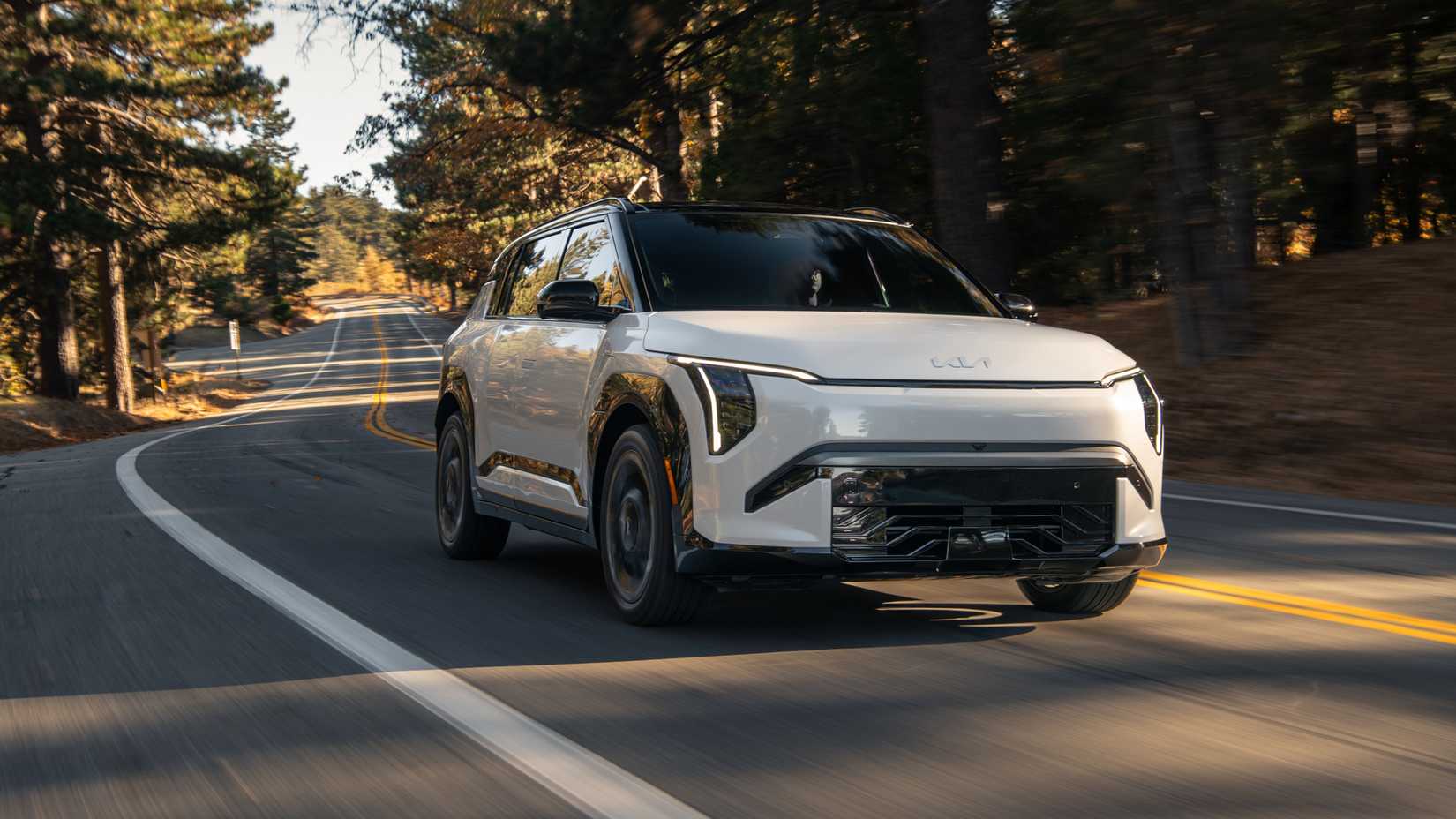 An action shot of the 2027 Kia EV3 on a backroad